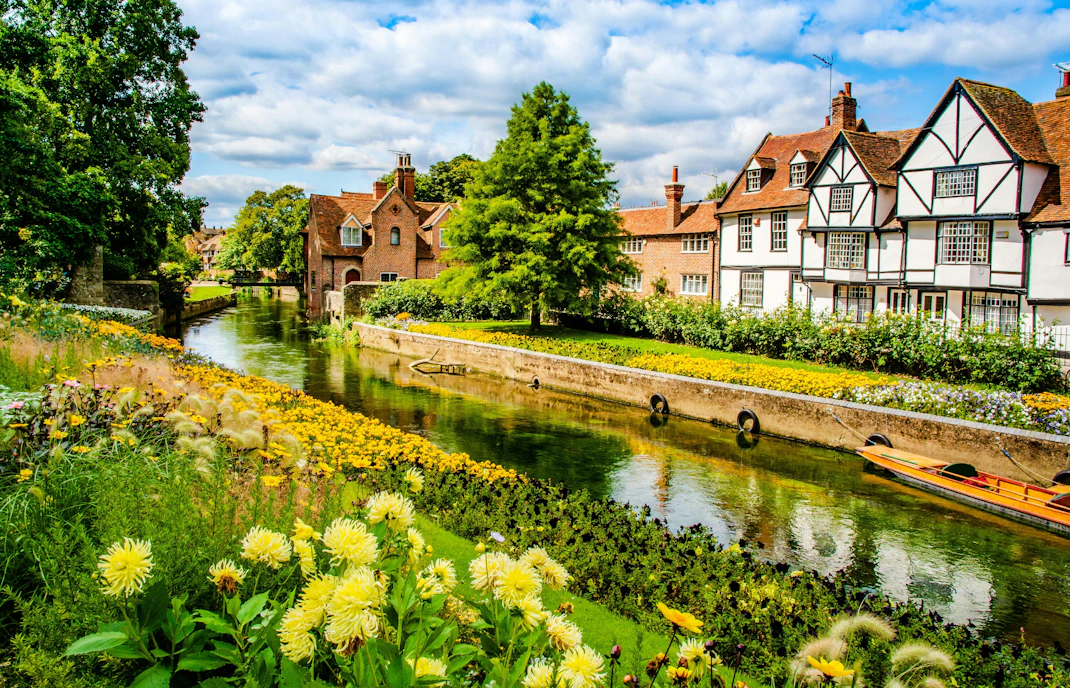 Great Stour river flowing by timbered houses near Westgate Gardens, Canterbury.
