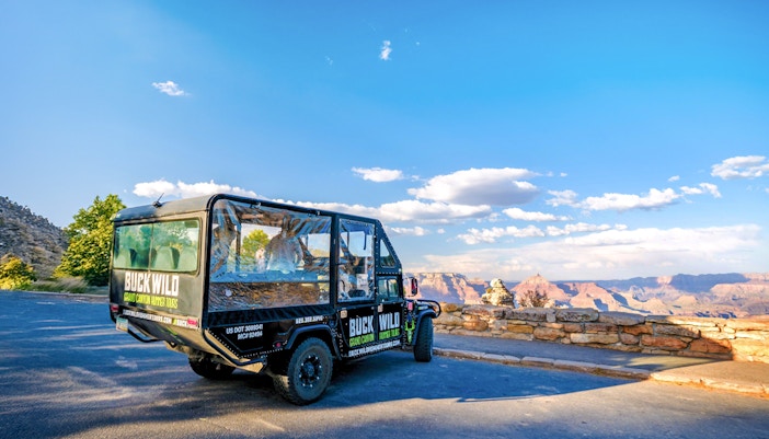Hummer parked near the Grand Canyon with scenic canyon view in the background.
