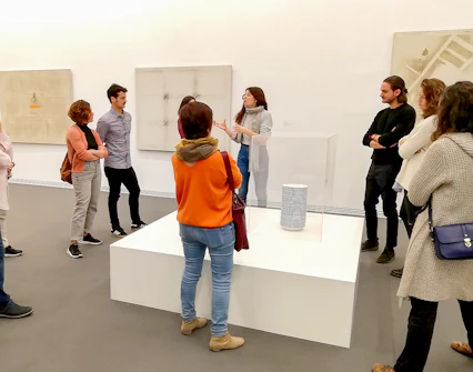 Visitors on a guided tour at Fundació Antoni Tàpies, viewing modern art exhibits.