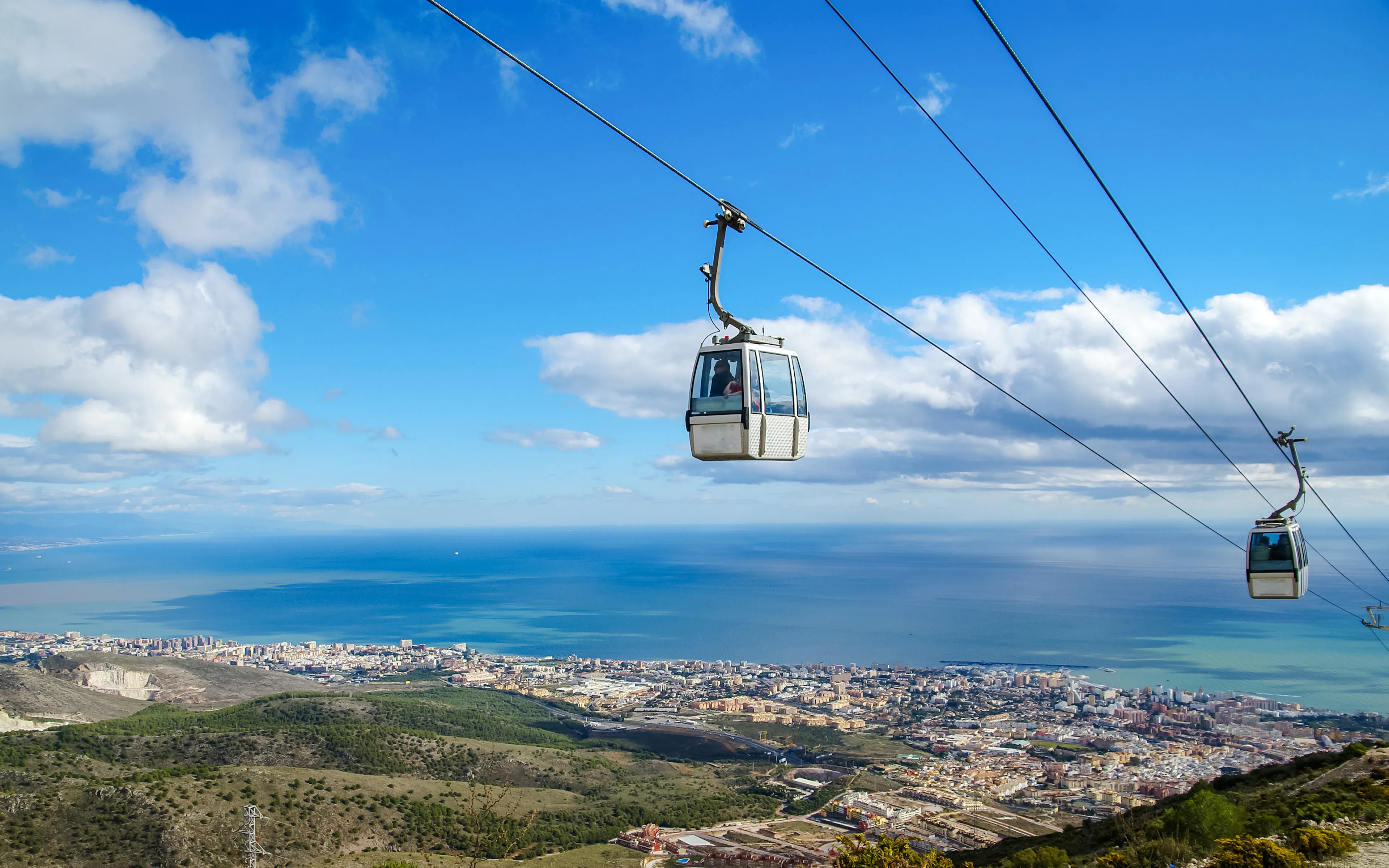 Cable car over Benalmadena with coastal view.