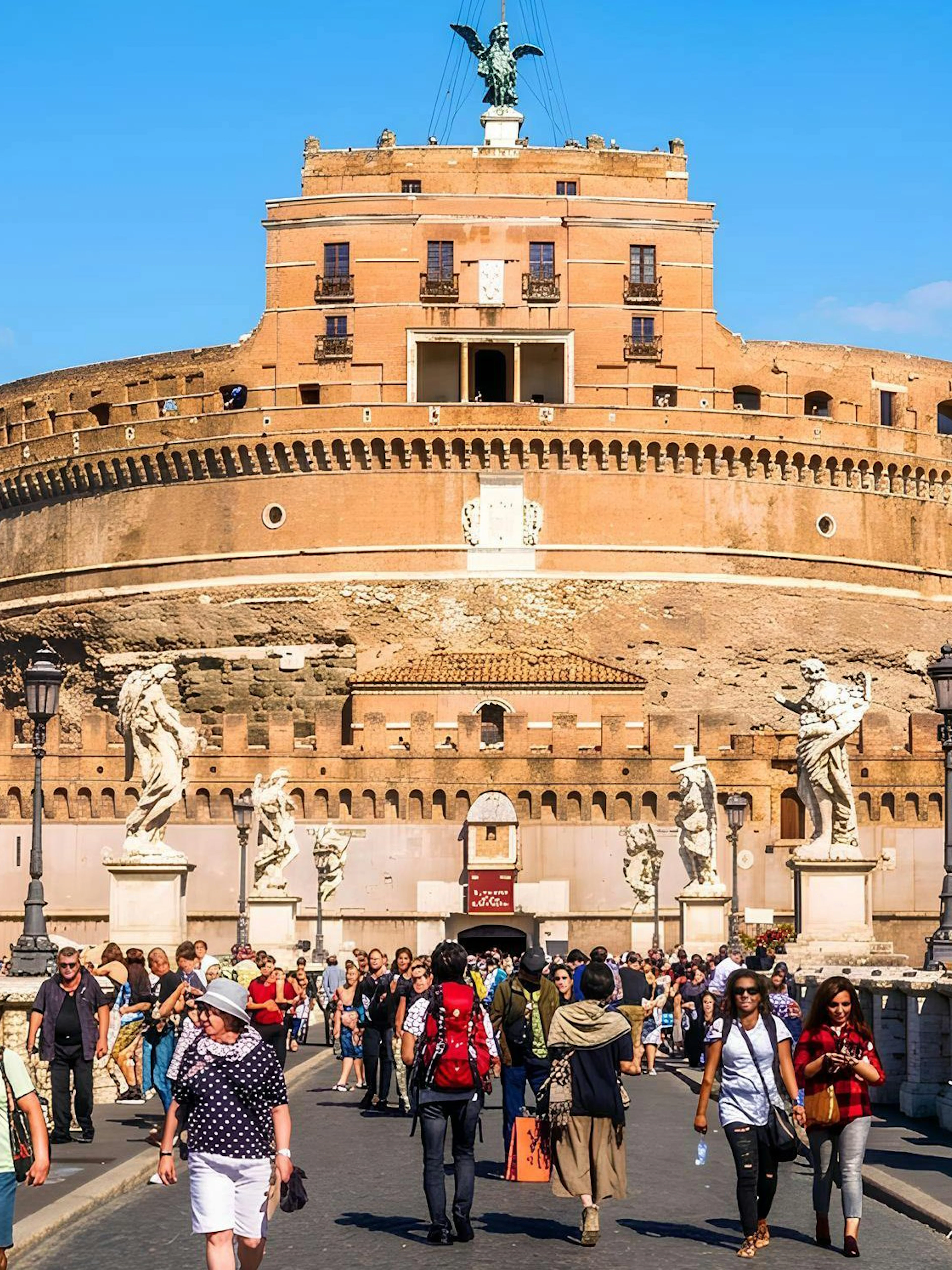 Visitors walking on the bridge towards Castel Sant'Angelo in Rome.
