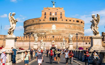 Visitors walking on the bridge towards Castel Sant'Angelo in Rome.