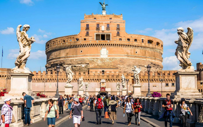 Visitors walking on the bridge towards Castel Sant'Angelo in Rome.