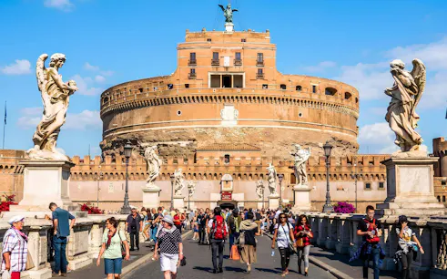 Visitors walking on the bridge towards Castel Sant'Angelo in Rome.