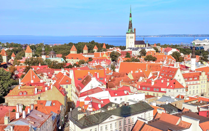 Tallinn's Old Town with red rooftops and St. Olaf's Church, view from Helsinki ferry trip.