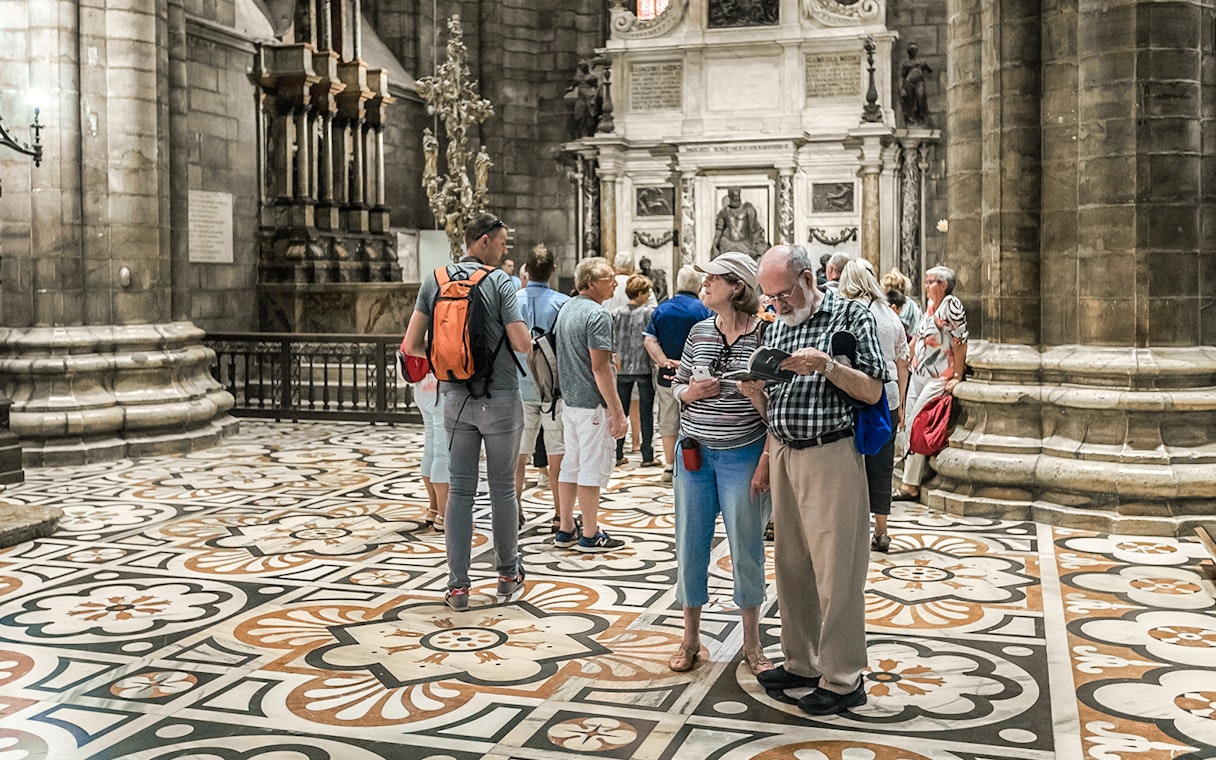 Tourists exploring the interior of Duomo Cathedral, Milan.