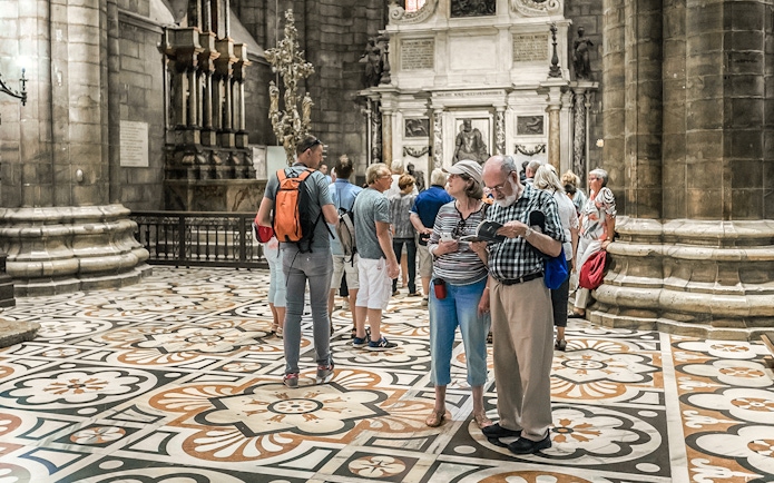 Tourists exploring the interior of Duomo Cathedral, Milan.