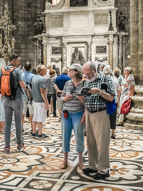 Tourists exploring the interior of Duomo Cathedral, Milan.