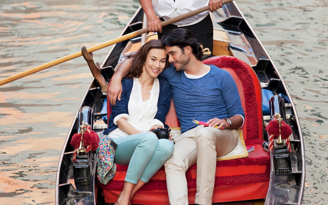 Couple enjoying a gondola ride in Venice, Italy.