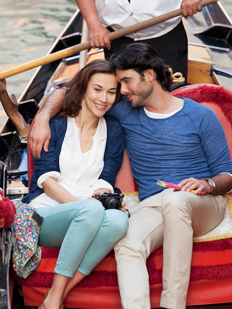 Couple enjoying a gondola ride in Venice, Italy.