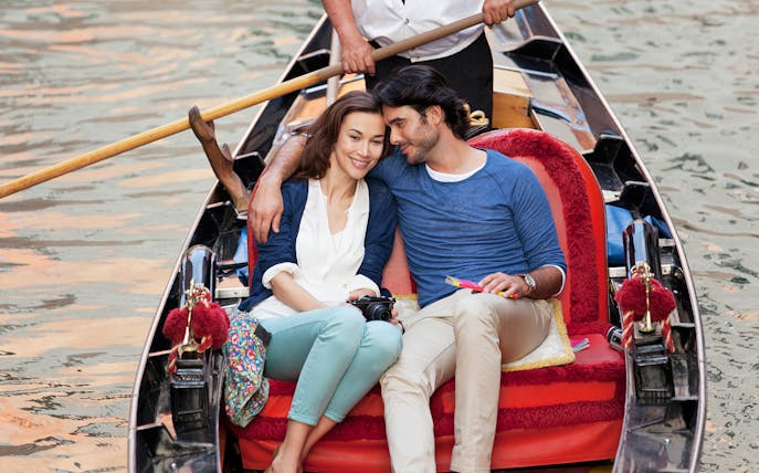 Couple enjoying a gondola ride in Venice, Italy.