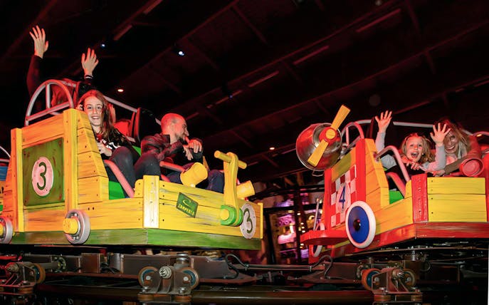 Visitors enjoying a colorful ride at Luna Farm Amusement Park.