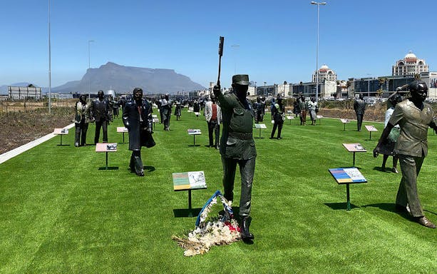 Statues at Long March to Freedom Exhibition with Table Mountain in the background, Cape Town.