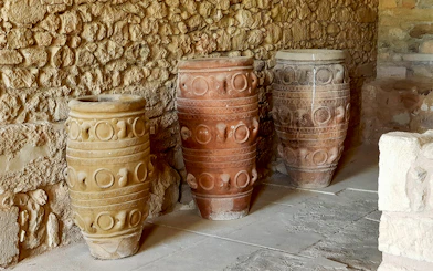 Ancient storage jars inside Knossos Palace, Crete, showcasing Minoan pottery design.