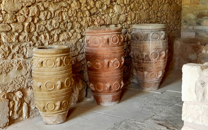 Ancient storage jars inside Knossos Palace, Crete, showcasing Minoan pottery design.