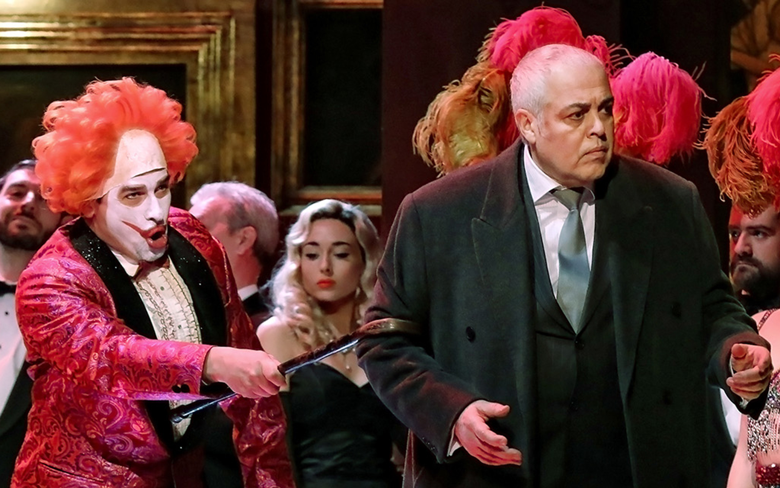 Performers in a Rigoletto show production with vibrant costumes and dramatic expressions.