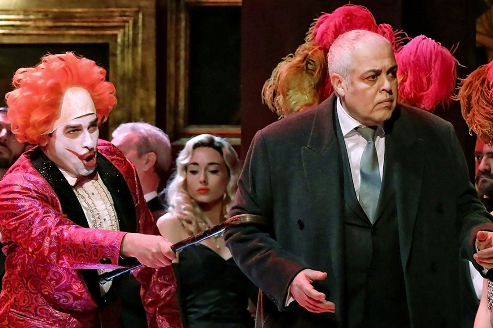 Performers in a Rigoletto show production with vibrant costumes and dramatic expressions.