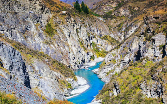 Skipper Canyon with river flowing between rocky cliffs in New Zealand.