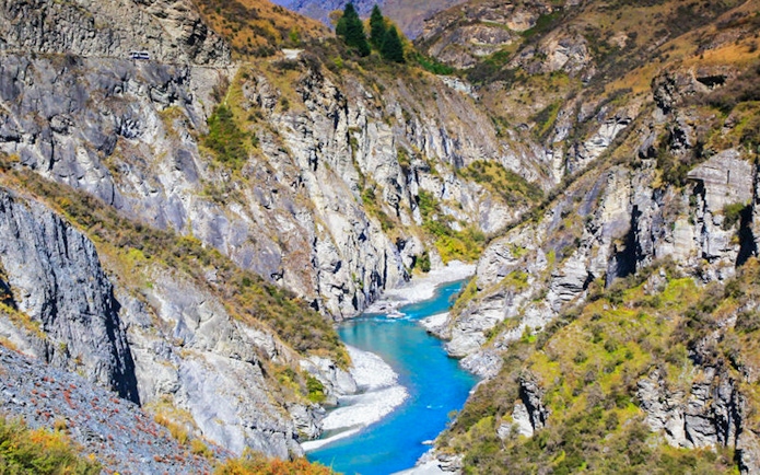 Skipper Canyon with river flowing between rocky cliffs in New Zealand.