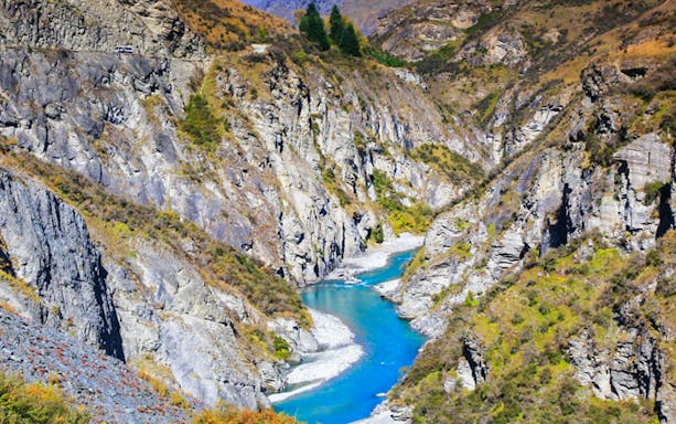 Skipper Canyon with river flowing between rocky cliffs in New Zealand.