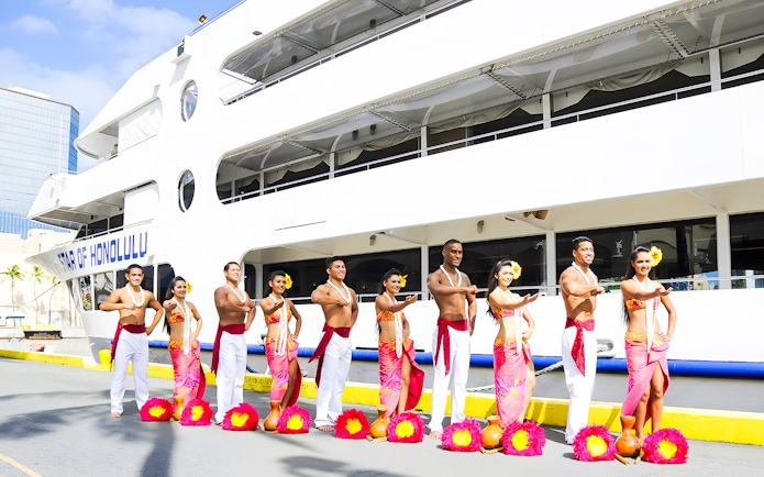 Performers in traditional attire in front of the Star of Honolulu, Three Star.