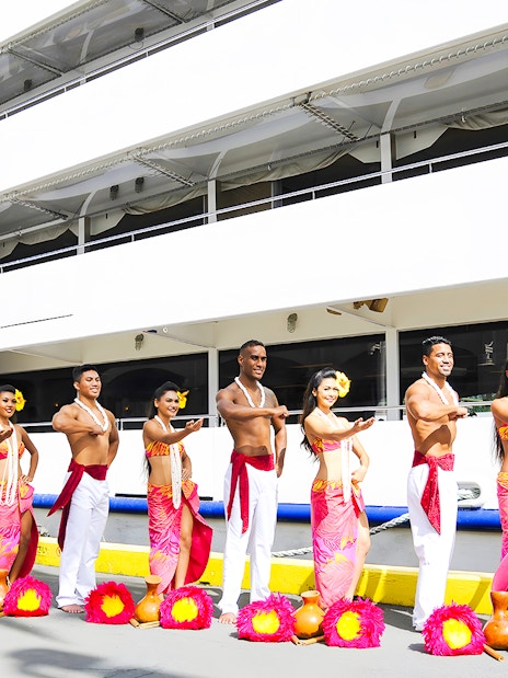 Performers in traditional attire in front of the Star of Honolulu, Three Star.