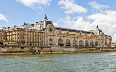Orsay Museum exterior along the Seine River in Paris, offering fast-track tickets and exhibitions.