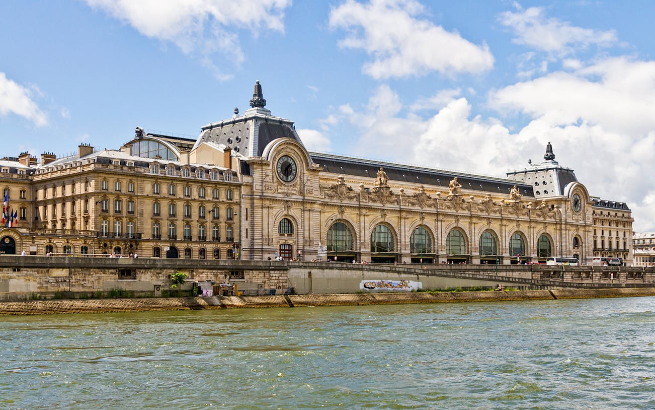 Orsay Museum exterior along the Seine River in Paris, offering fast-track tickets and exhibitions.