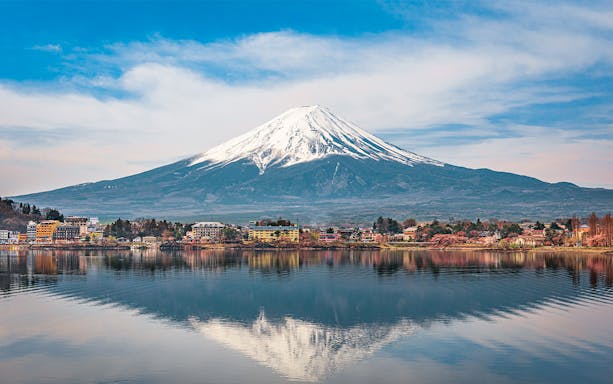 Mt Fuji reflected in Lake Kawaguchi, Japan, with surrounding townscape, part of Hakone tour.