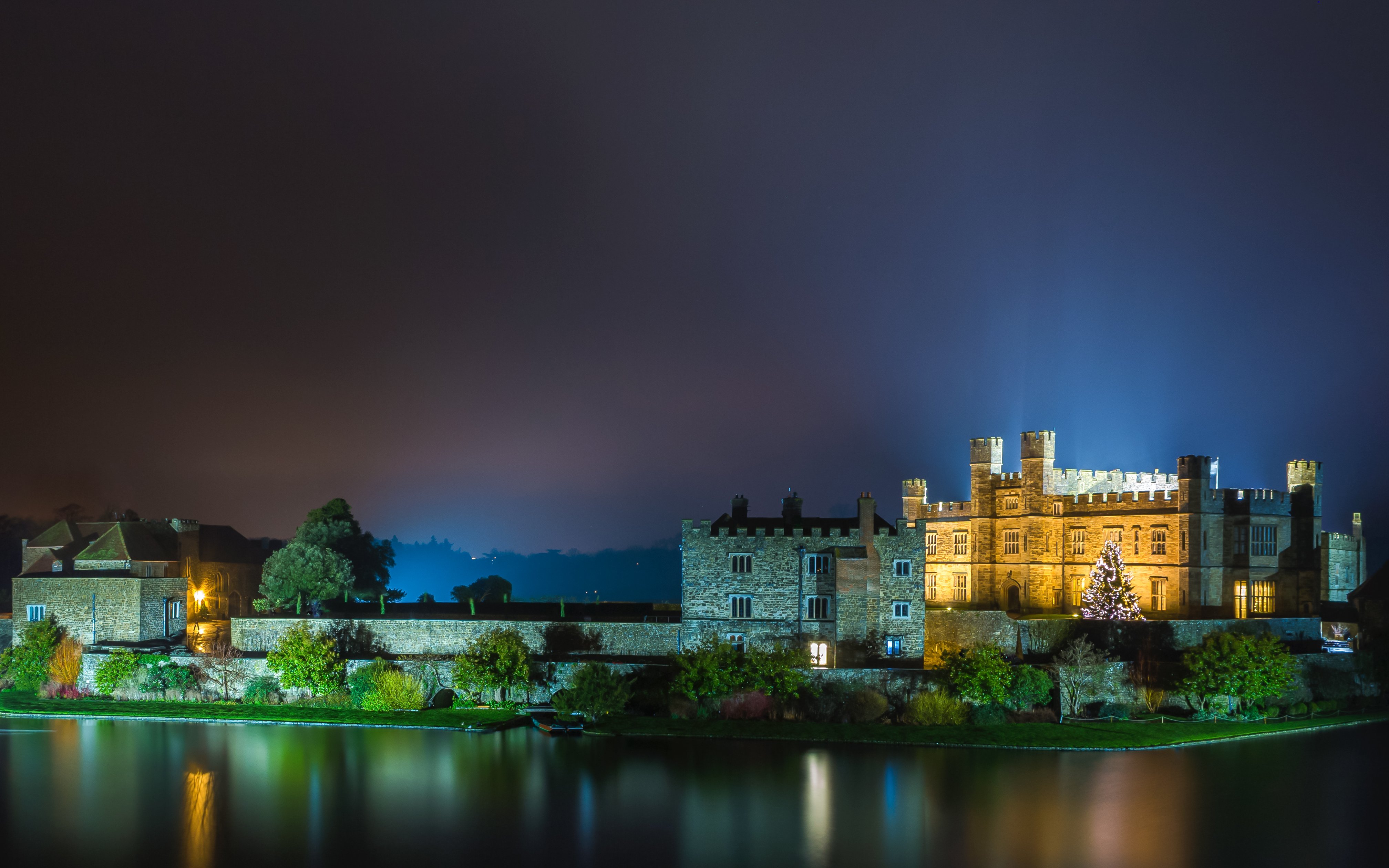 Leeds Castle illuminated at night with Christmas tree, Kent, England.