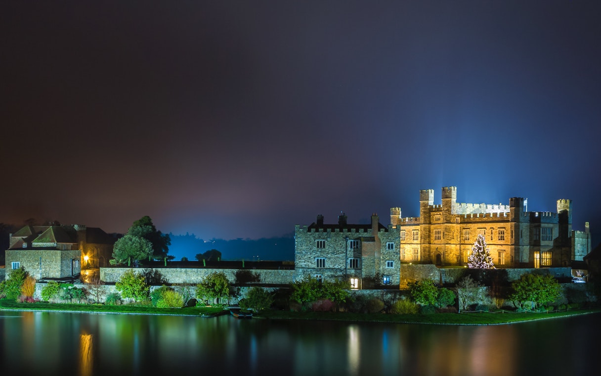 Leeds Castle illuminated at night with Christmas tree, Kent, England.
