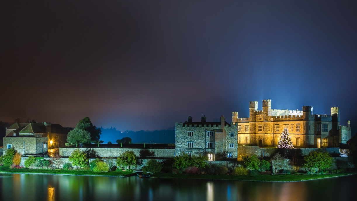 Leeds Castle illuminated at night with Christmas tree, Kent, England.