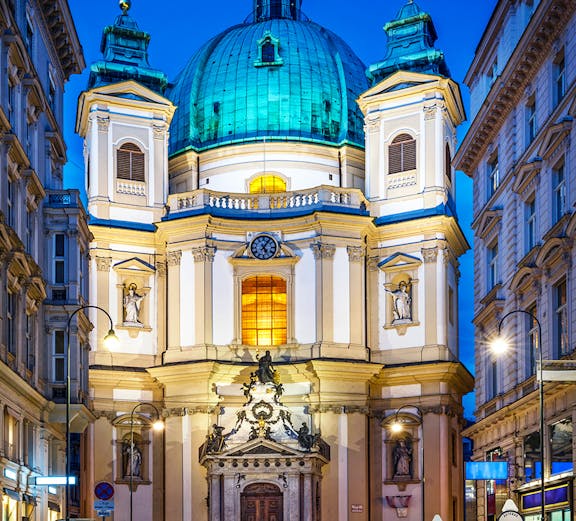 St. Peter's Church facade illuminated at night, Vienna concert venue.