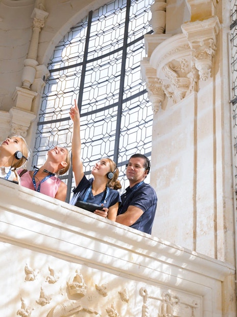 Visitors exploring the ornate interior of Chambord Castle.