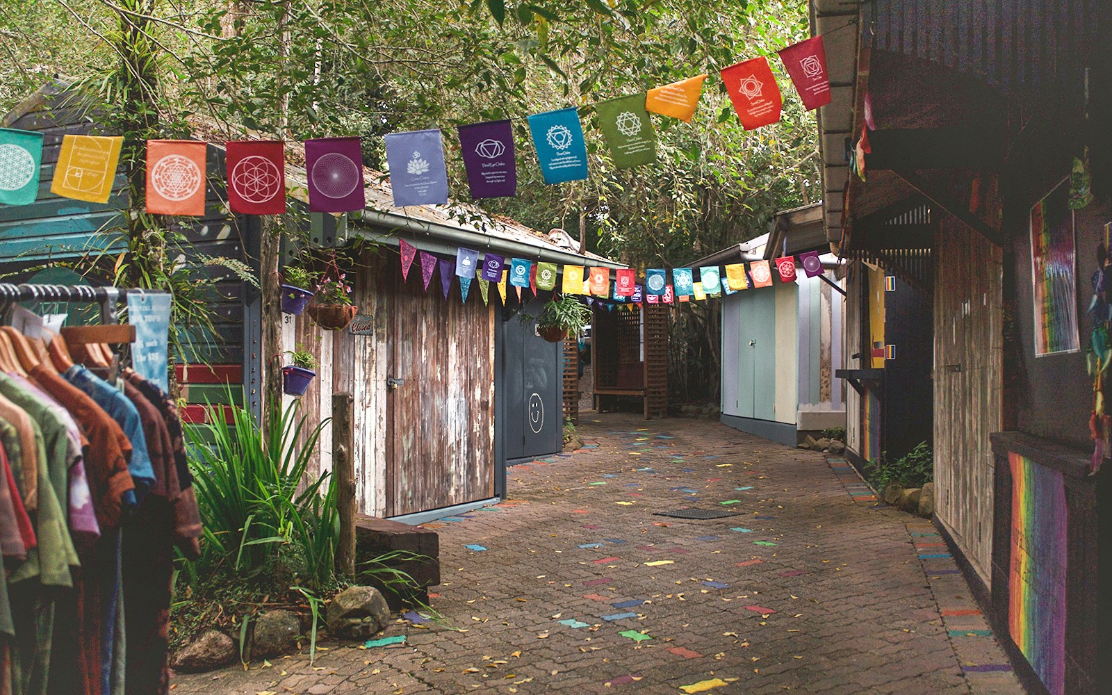 Colorful flags and rustic shops at Rainforestation Nature Park, Cairns.