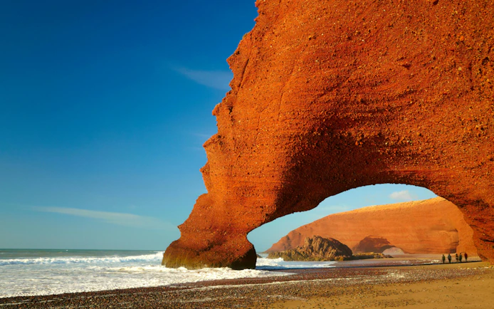 Red rock arch on Atlantic Ocean coast in Morocco.