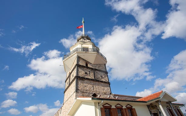 Maiden's Tower with Turkish flag against blue sky, Istanbul.