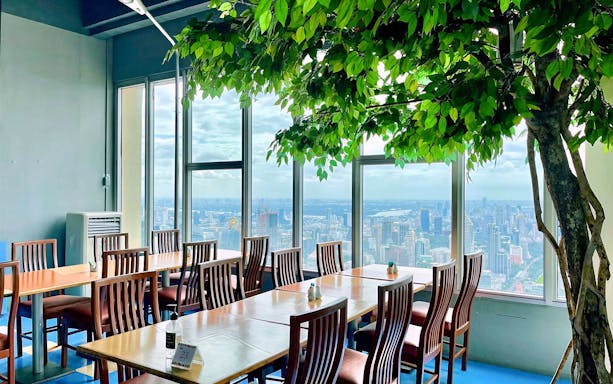Dining area with city view at Baiyoke Sky Hotel, Bangkok, for Festive Special Dinner.