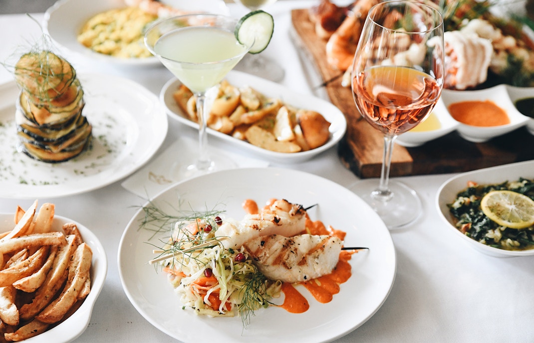 Outdoor dining setup with tables and chairs overlooking the Mediterranean Sea in Malta.