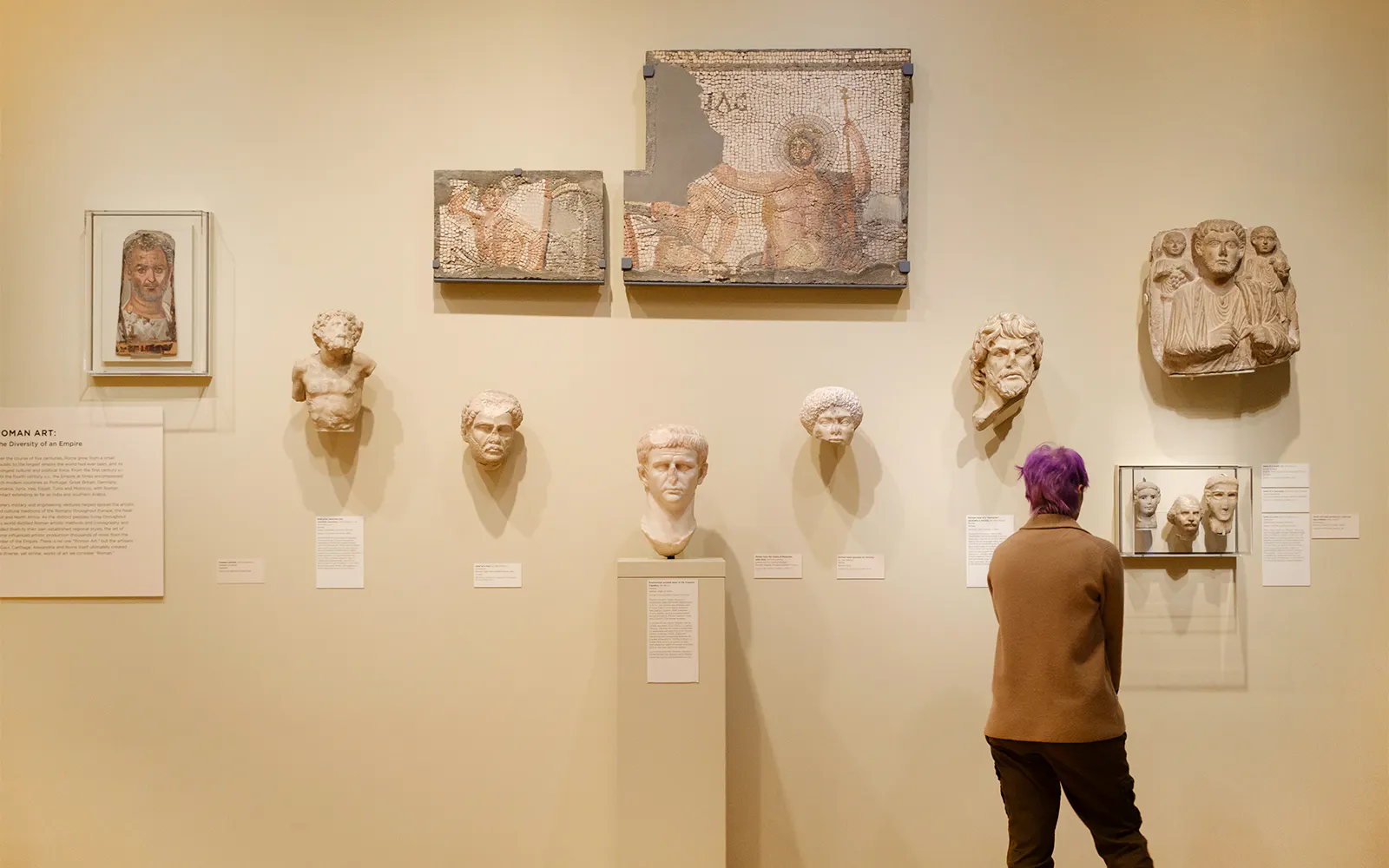 Woman viewing Roman artifacts at Seattle Art Museum.