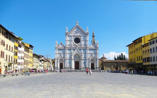 Basilica of Santa Croce in Florence with tourists in the square.