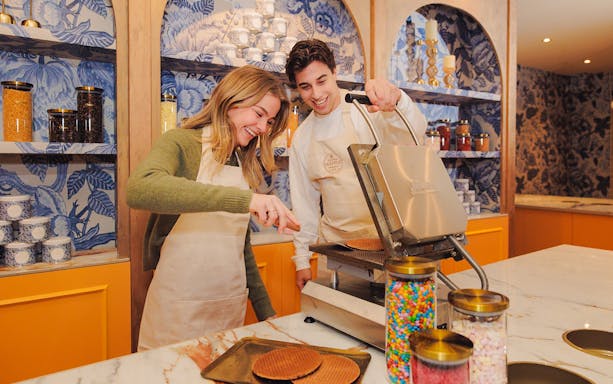 Guests making stroopwafels at a workshop in Amsterdam.