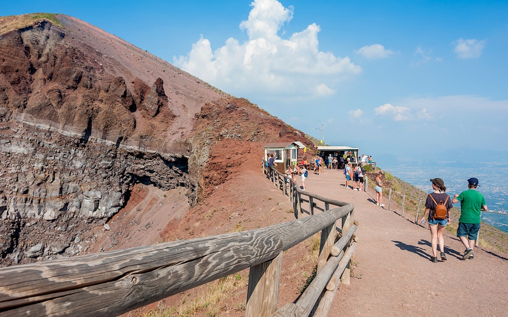 Visitors walking along the path on Mount Vesuvius, Italy, with audio guide stations.