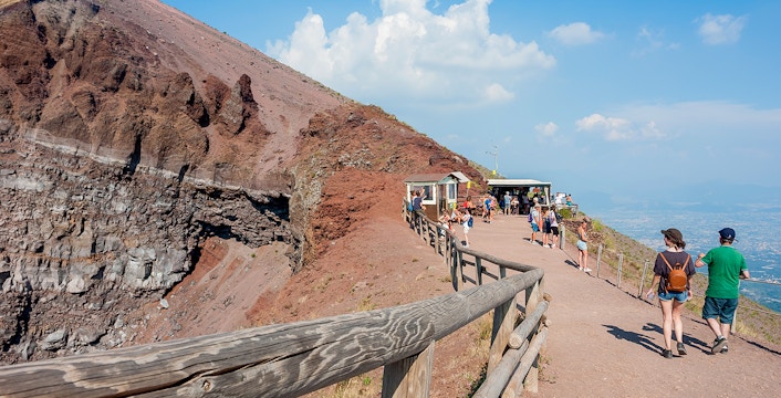 Visitors walking along the path on Mount Vesuvius, Italy, with audio guide stations.