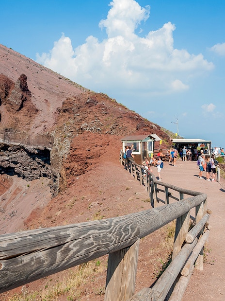 Visitors walking along the path on Mount Vesuvius, Italy, with audio guide stations.