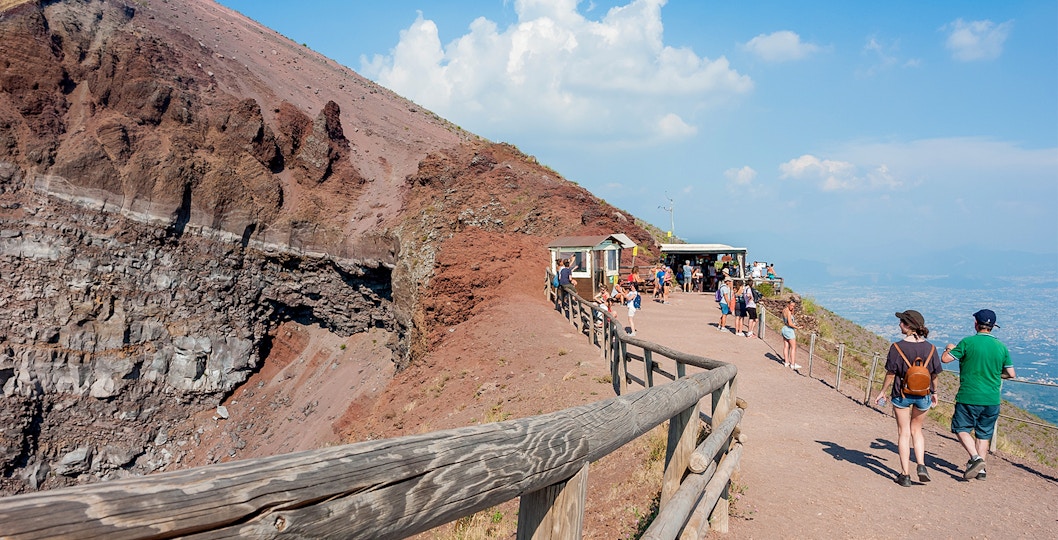 Visitors walking along the path on Mount Vesuvius, Italy, with audio guide stations.