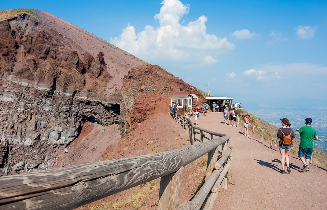 Visitors walking along the path on Mount Vesuvius, Italy, with audio guide stations.