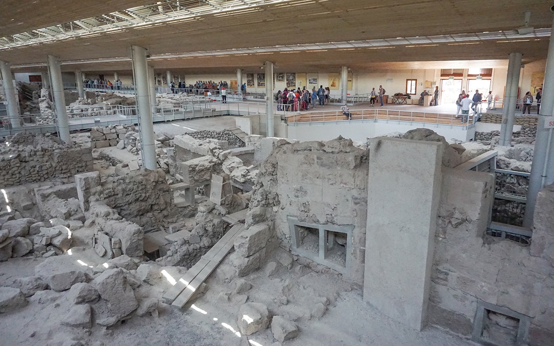 Akrotiri archaeological site with visitors on a guided tour in Santorini.