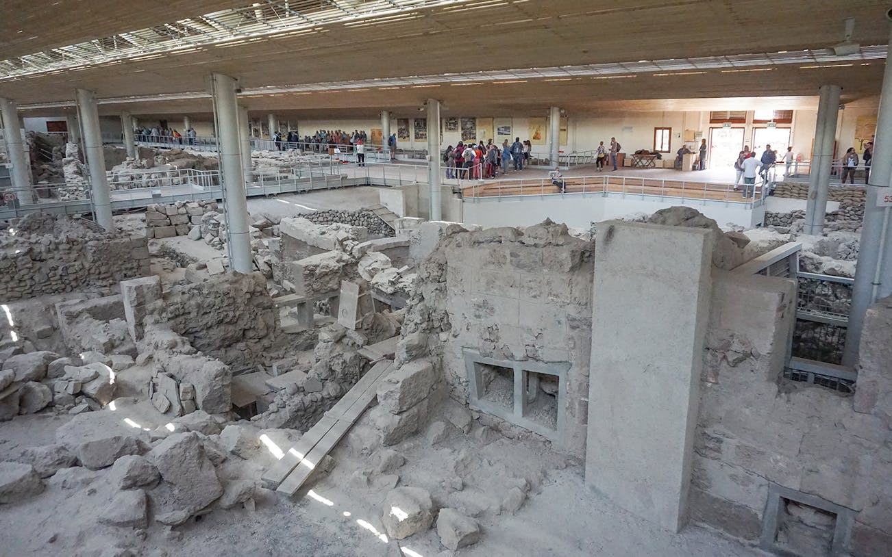 Akrotiri archaeological site with visitors on a guided tour in Santorini.
