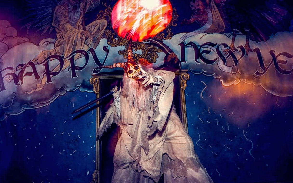 Ghostly figure with a skull staff at Universal Studios Hollywood Halloween Horror Nights.